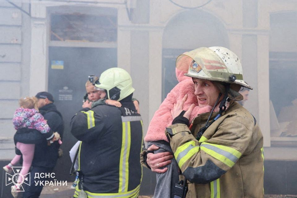 Rescuers evacuate children from a kindergarten hit by Russian drone strike in Kharkiv yesterday. Photo: Reuters
